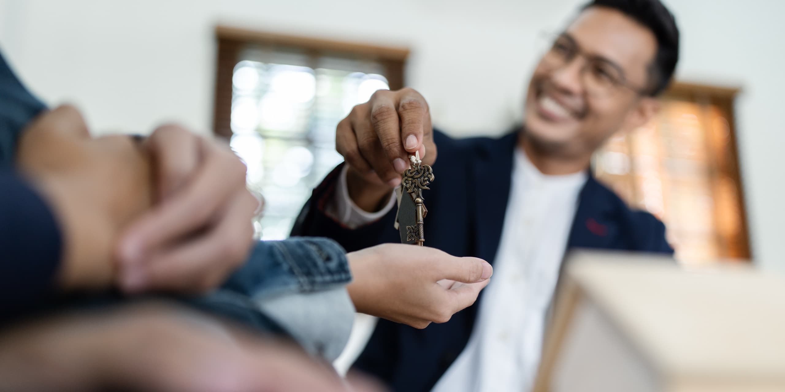 Real estate agent handing over keys to a new home