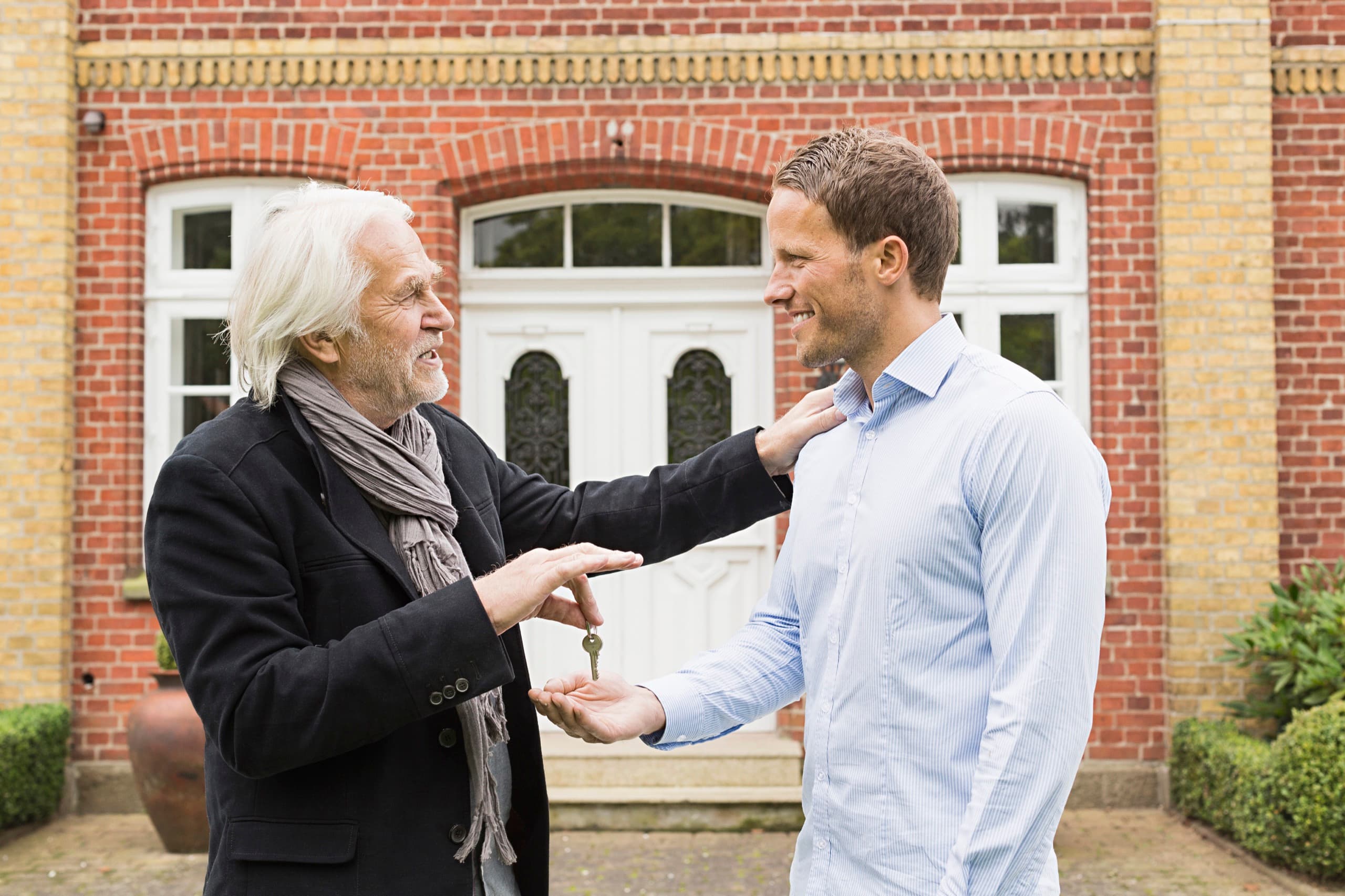 Father giving house key to son